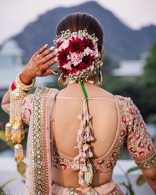 This bridal bun with a bunch of colorful flowers and baby breath's flower  is perfect to wear with your bridal lehenga on your big day. This… |  Instagram