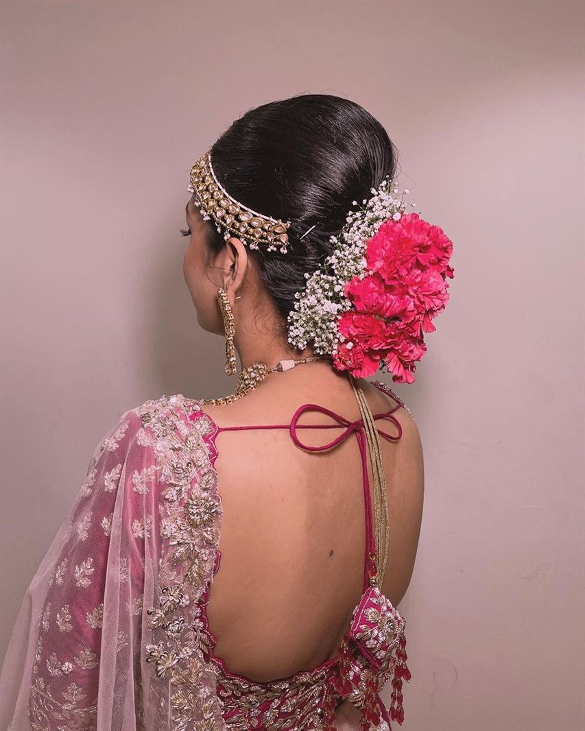Bridal Bun Hairstyle With Pink And White Flowers